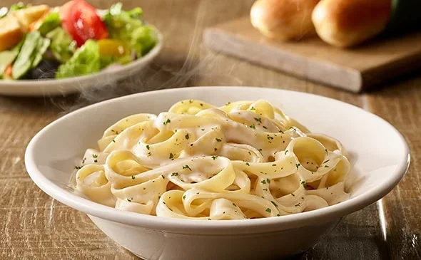 Get the Lunch-sized Fettuccine Alfredo served with salad and breadsticks. - Olive Garden Menu 2025