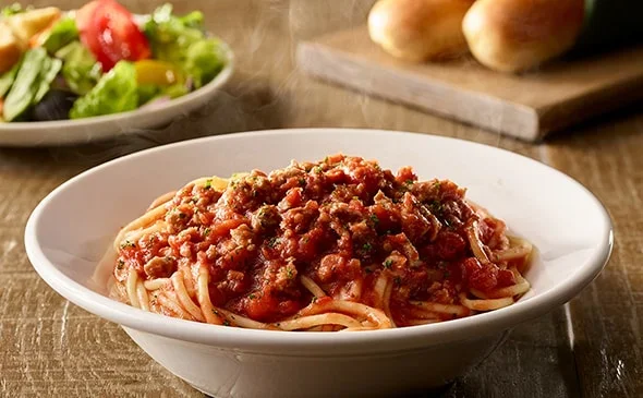 Get the Lunch-sized Spaghetti with Meat Sauce served with salad and breadsticks. - Olive Garden Menu 2025